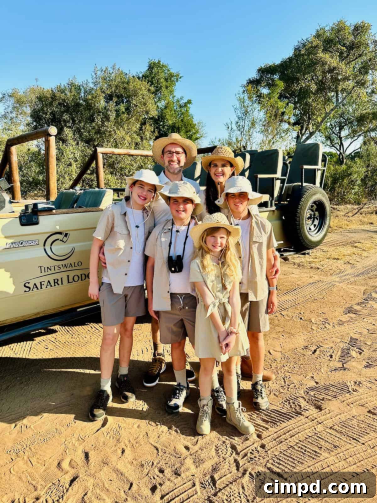 Brown family on their first game drive in South Africa, wearing neutral safari attire.