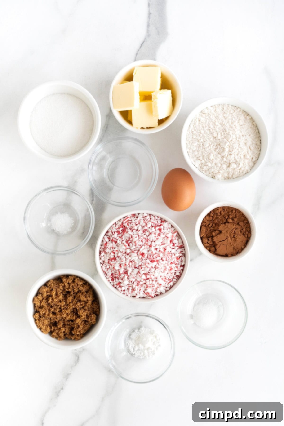 A beautifully arranged flat lay of all the fresh ingredients needed to bake irresistible chocolate cookies with a vibrant peppermint crunch topping.