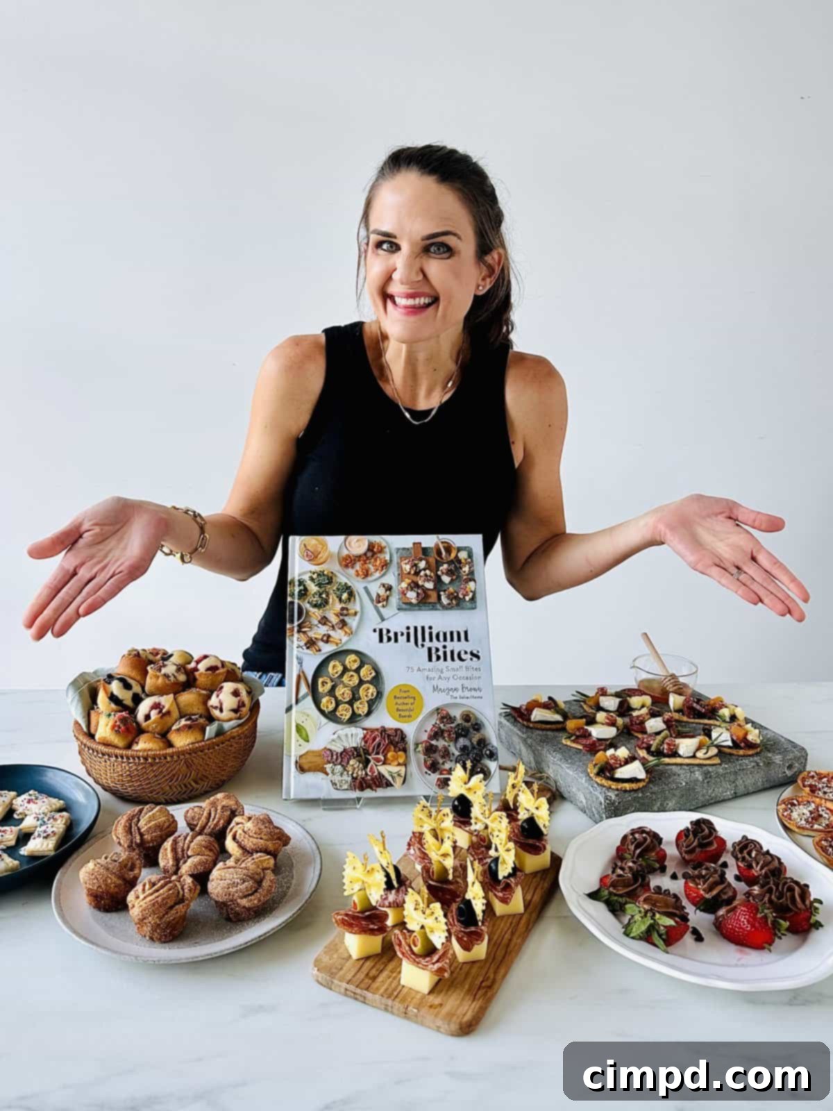 Cookbook author Maegan Brown presenting her cookbook, Brilliant Bites and a recipe.