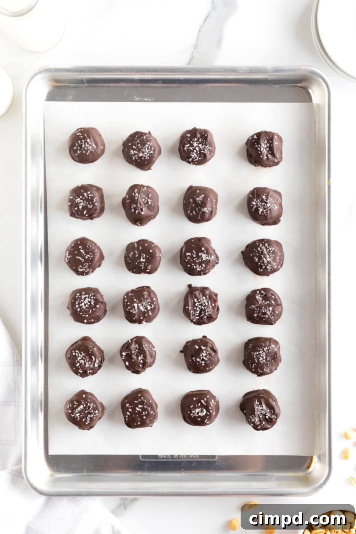 24 Take 5 Candy Bar Bites on a parchment lined aluminum baking sheet.
