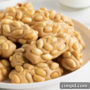 PayDay Treat Squares 10 A large white plate of payday candy bar bites on a white counter.