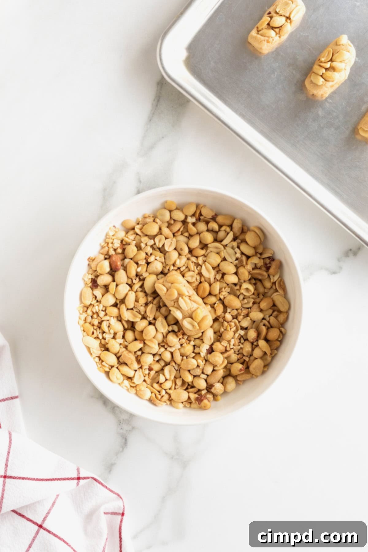 PayDay Treat Squares 7 Payday candy bar bite dipped in peanuts in a small white bowl.