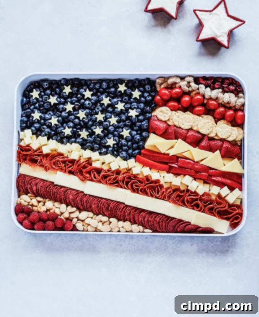 An American Flag themed cheese tray, artfully arranged with red, white, and blue ingredients, ideal for patriotic celebrations.