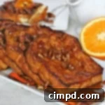 Signature Orange Pecan French Toast 3 Orange Pecan French Toast with maple syrup and orange slices