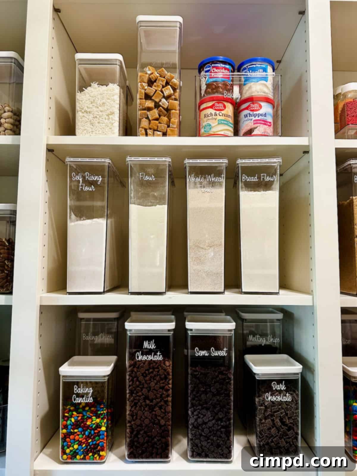 An array of different kinds of flours neatly organized in clear, airtight containers on pantry shelves.