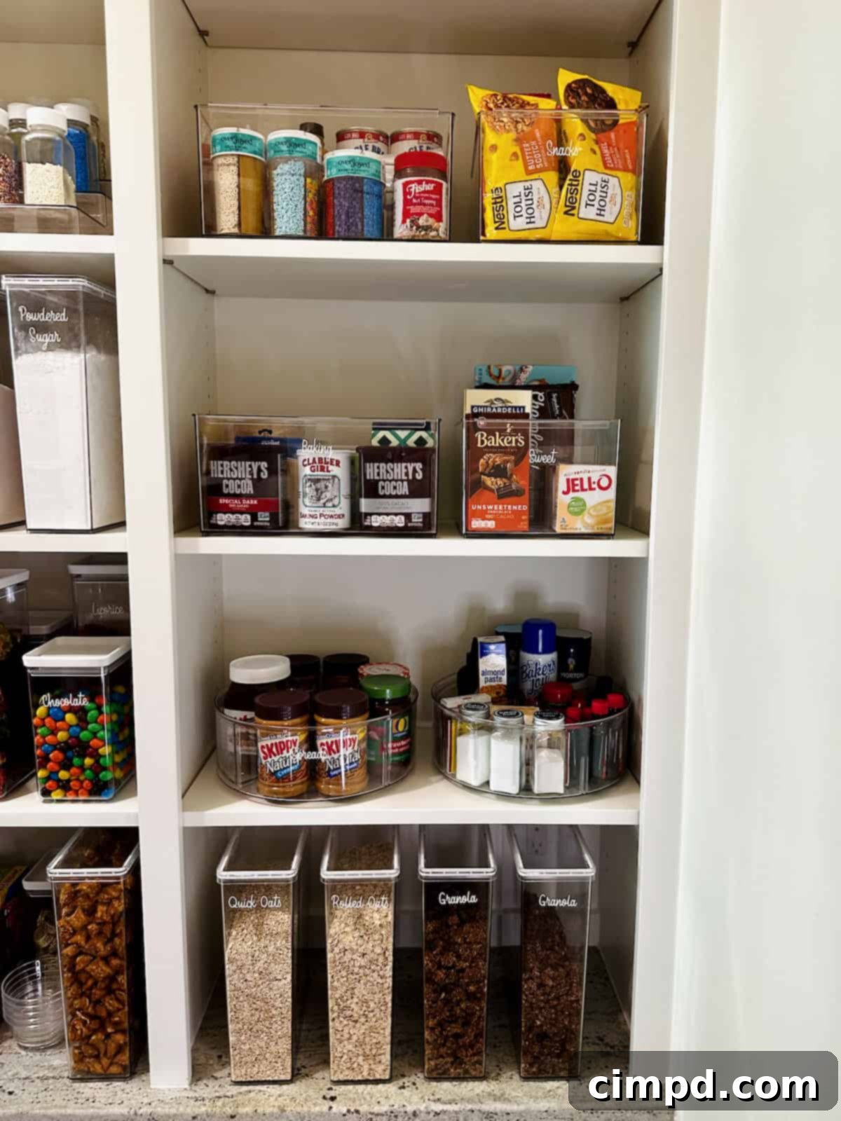 Assorted baking chocolates, including bars and cocoa powders, neatly arranged on a pantry shelf.