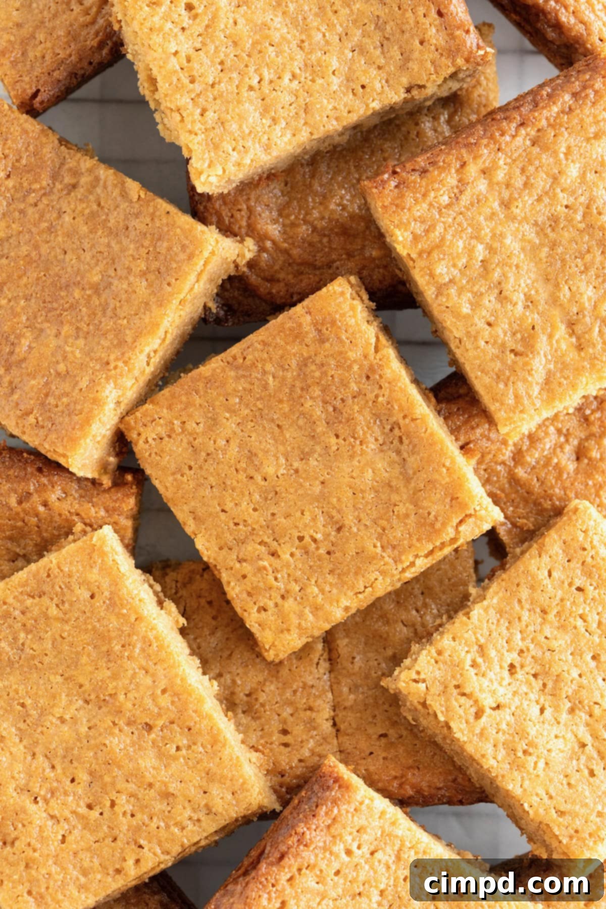 A generous pile of freshly baked peanut butter blondies, ready to be enjoyed.