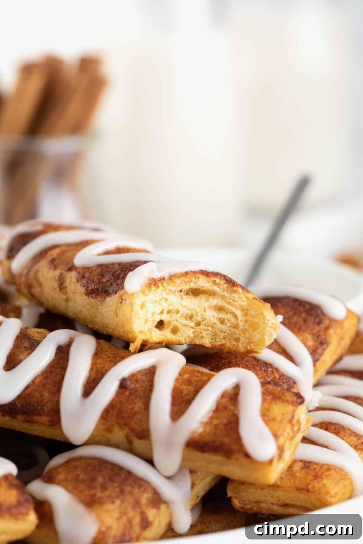 Gooey Cinnamon Fries 4 A cinnamon roll stick with a bite taken out of it.