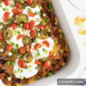 Loaded Frito Chili Bake 11 A white casserole dish of Frito Chili Pie casserole on a white marble counter.