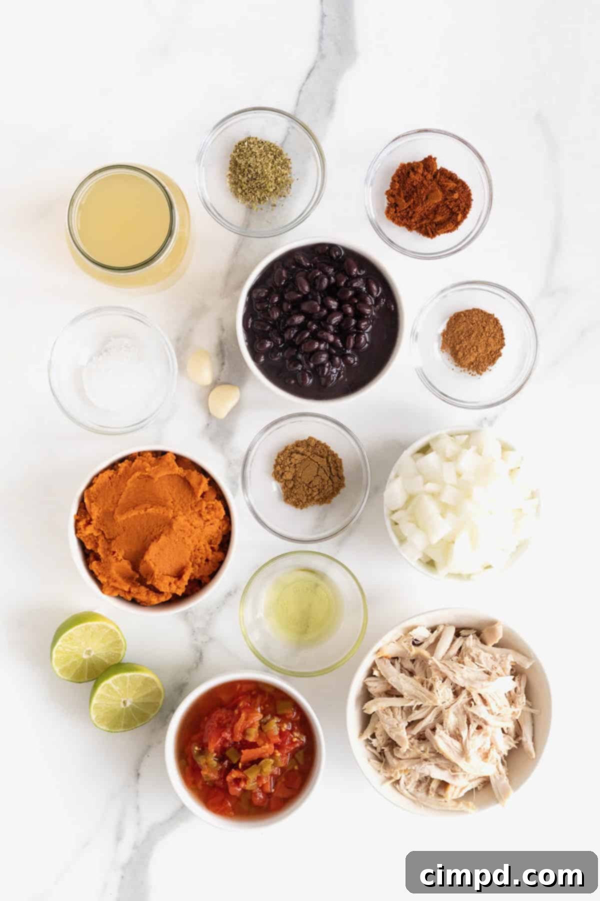 Harvest Pumpkin Chicken Chili 6 Ingredients to make Pumpkin Chicken Chili in small glass dishes on a white marble counter.