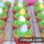 Egg Hunt Cookie Cups with green icing and Cadbury mini eggs.