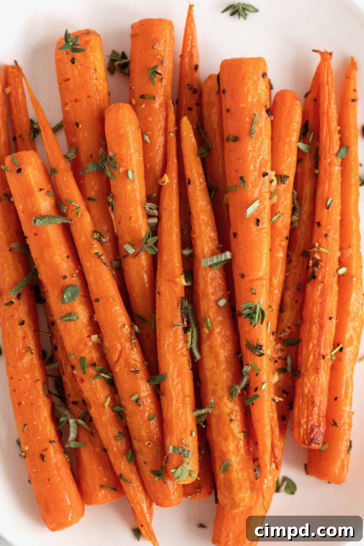 Golden Roasted Carrots 8 A simple white oval serving plate elegantly presenting a mound of golden roasted carrots.