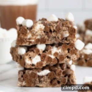Cozy Hot Cocoa Krispies Squares 11 A square Hot Cocoa Krispies Treat, topped with mini marshmallows, ready to be enjoyed.