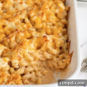 A white ceramic casserole dish of baked macaroni and cheese.