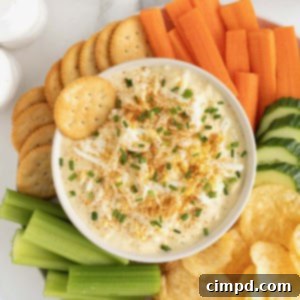 A white serving bowl of deviled egg dip.
