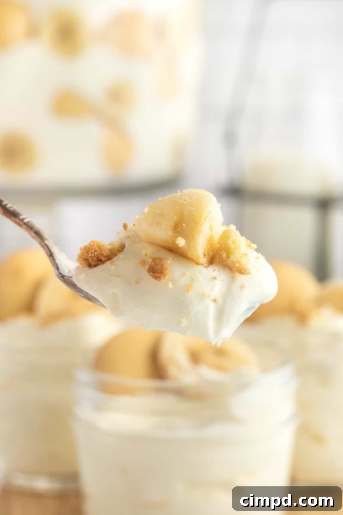 A close-up view of the creamy vanilla pudding, sliced fresh bananas, and delicate vanilla wafers layered beautifully in The Best Banana Pudding.