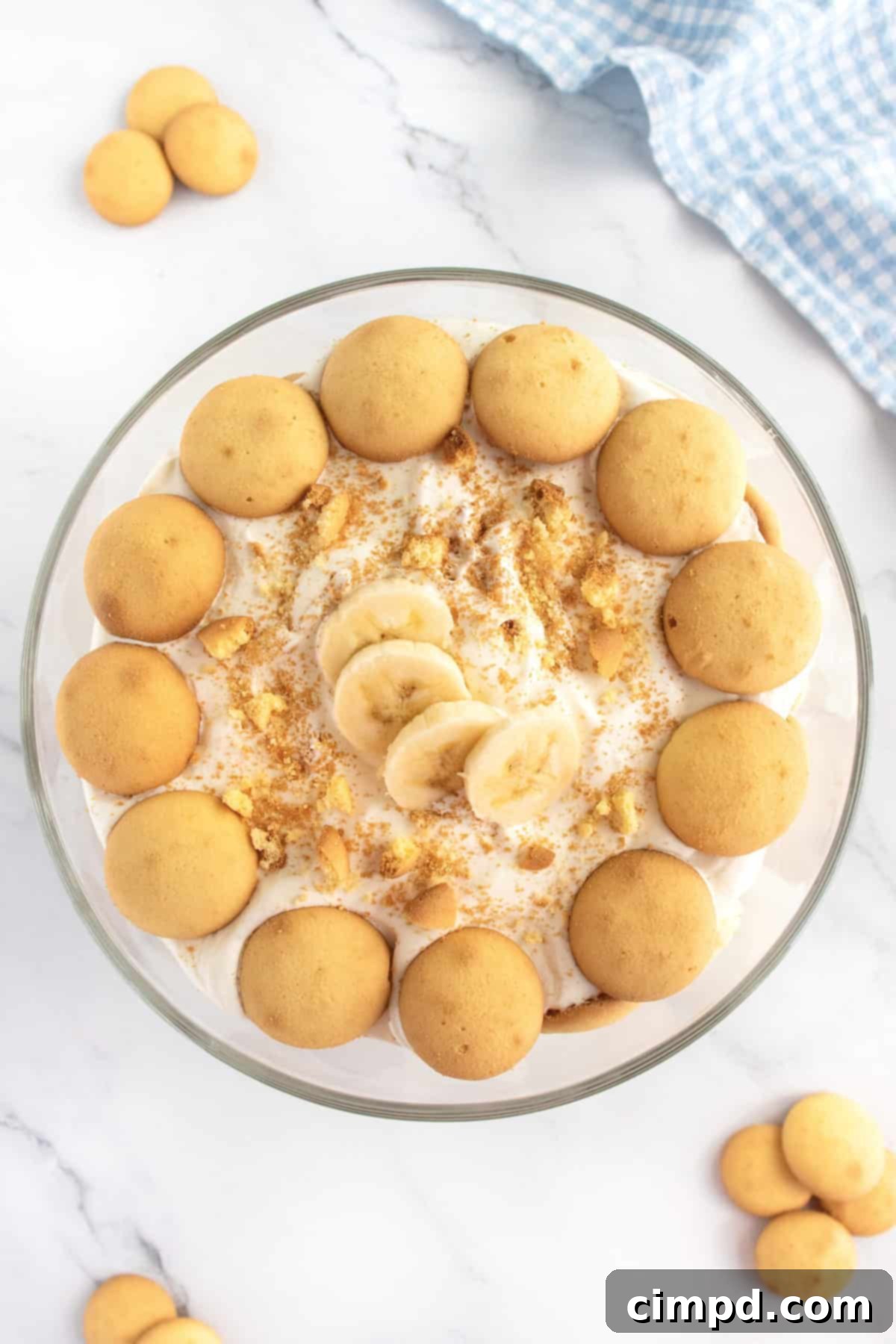 A close-up of The Best Banana Pudding in a glass bowl, showcasing the rich, creamy texture and the golden vanilla wafers within the layers.