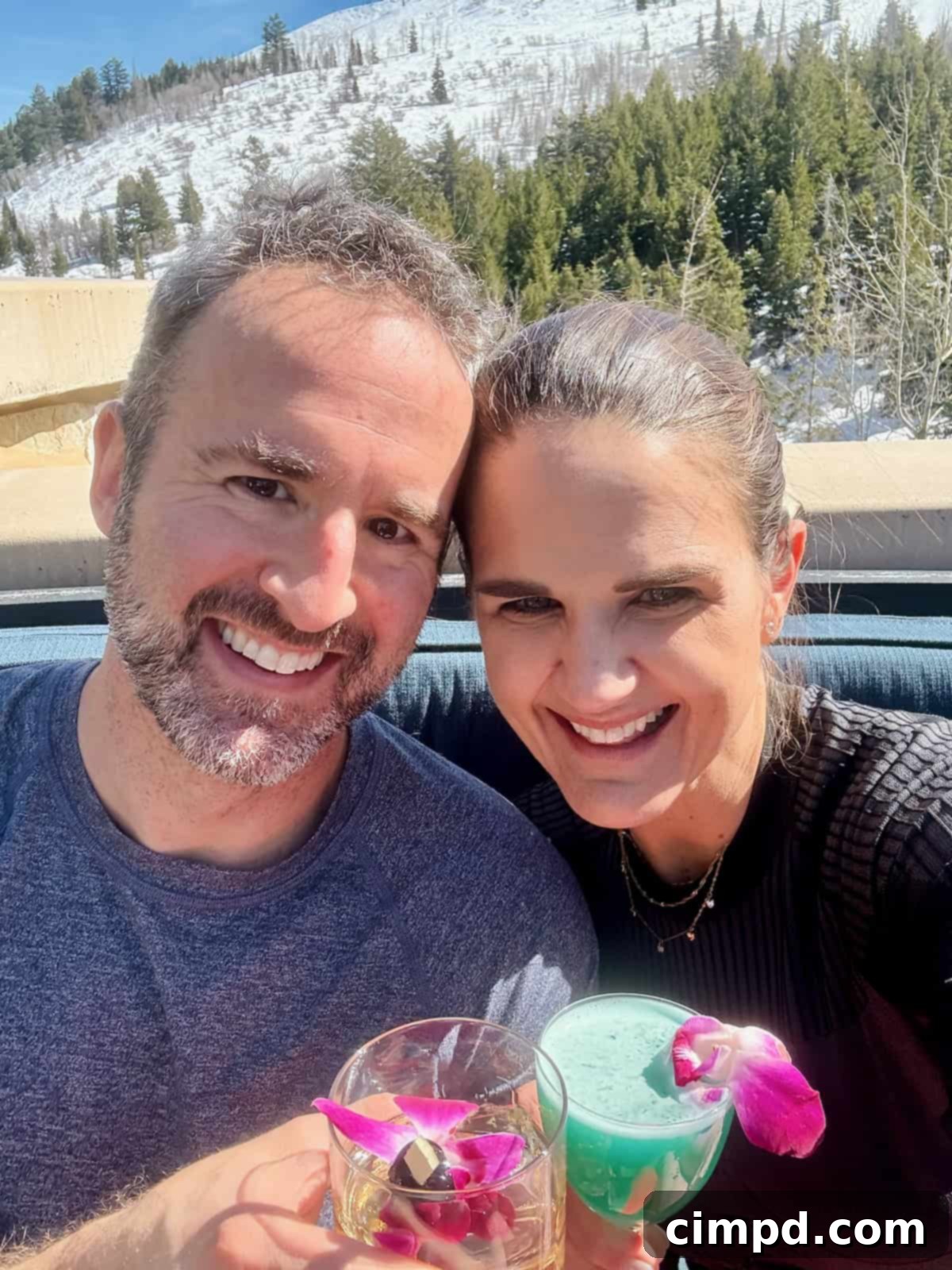 Brandon and Maegan enjoying cocktails on a sun-drenched patio at the St. Regis.