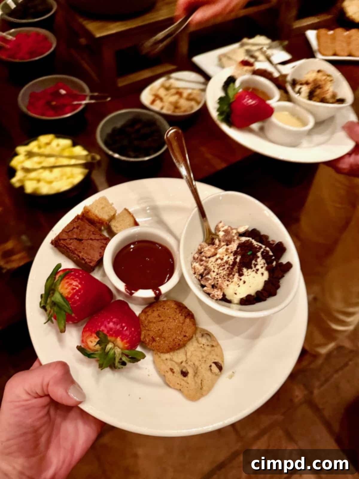 An inviting fondue bar at Fireside Dining, laden with various chocolates, fruits, and desserts.