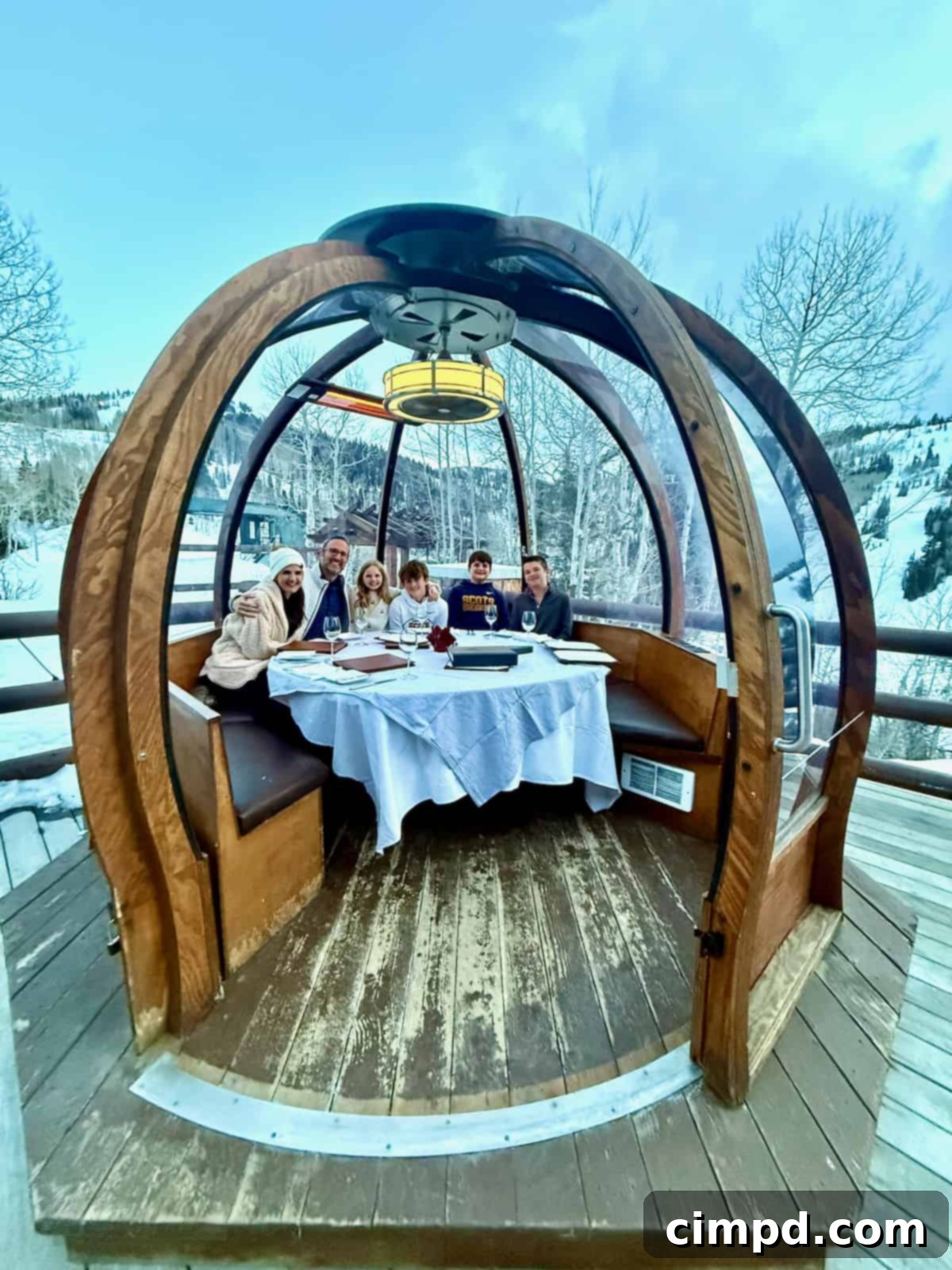 The Brown family enjoying a cozy and unique dinner experience in an Alpenglobe at Stein Eriksen Lodge.