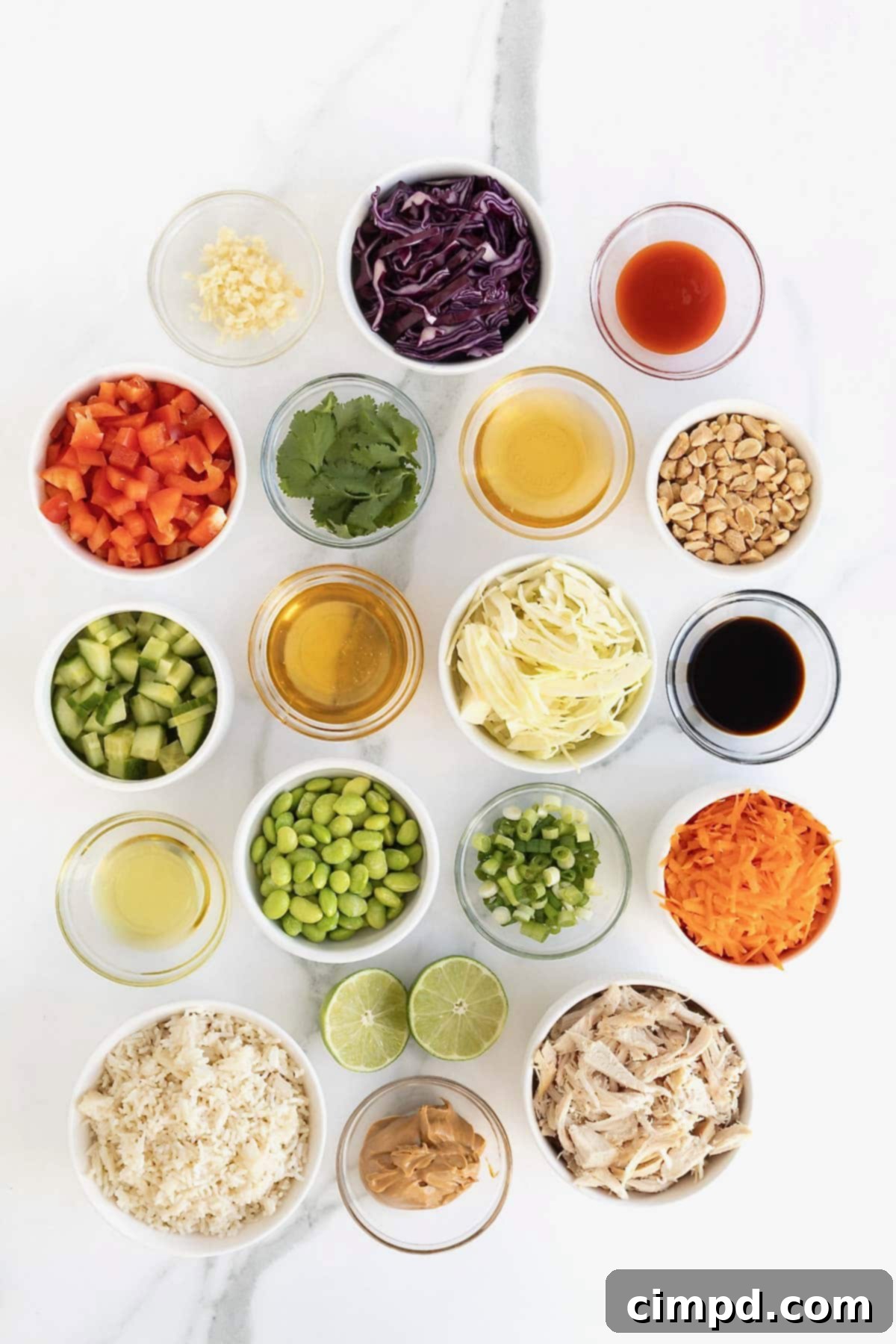 Ingredients to make crispy rice salad in small glass dishes on a white marble counter.