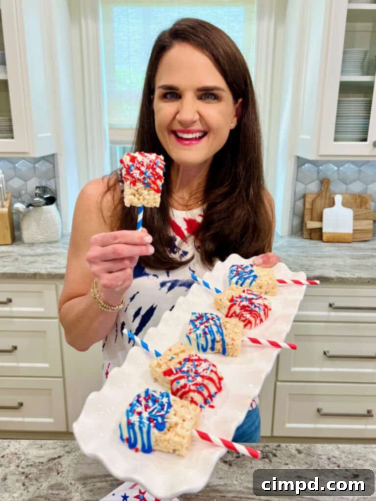 Simple Star-Spangled Bites 3 Maegan Brown, The BakerMama, proudly holding a plate of patriotic Rice Krispies treats, ready for a festive celebration.