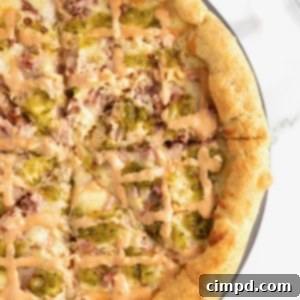 A stuffed crust Reuben pizza on an aluminum pizza pan.