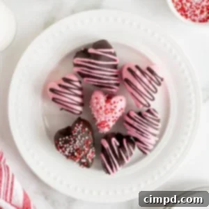 Sweetheart Chocolate Strawberries 13 Seven heart-shaped chocolate covered strawberries on a white plate with bead detail.