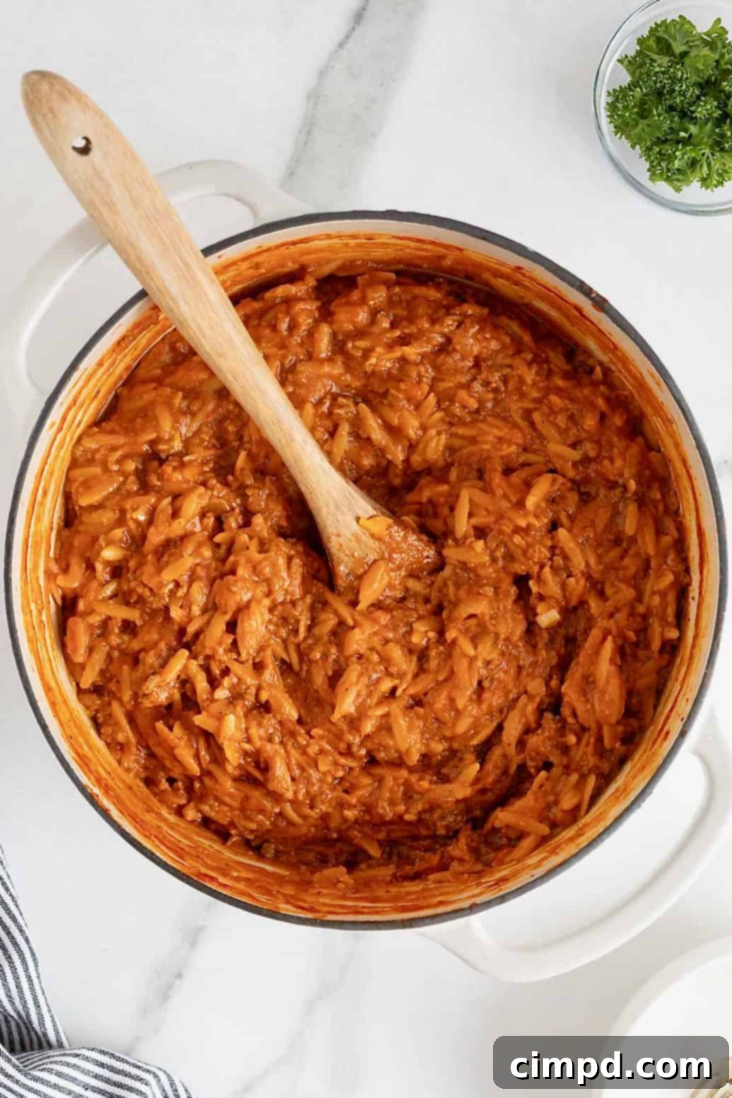One-Pot Sloppy Joe Orzo 2 A white Dutch oven of sloppy Joe orzo on a white marble counter.