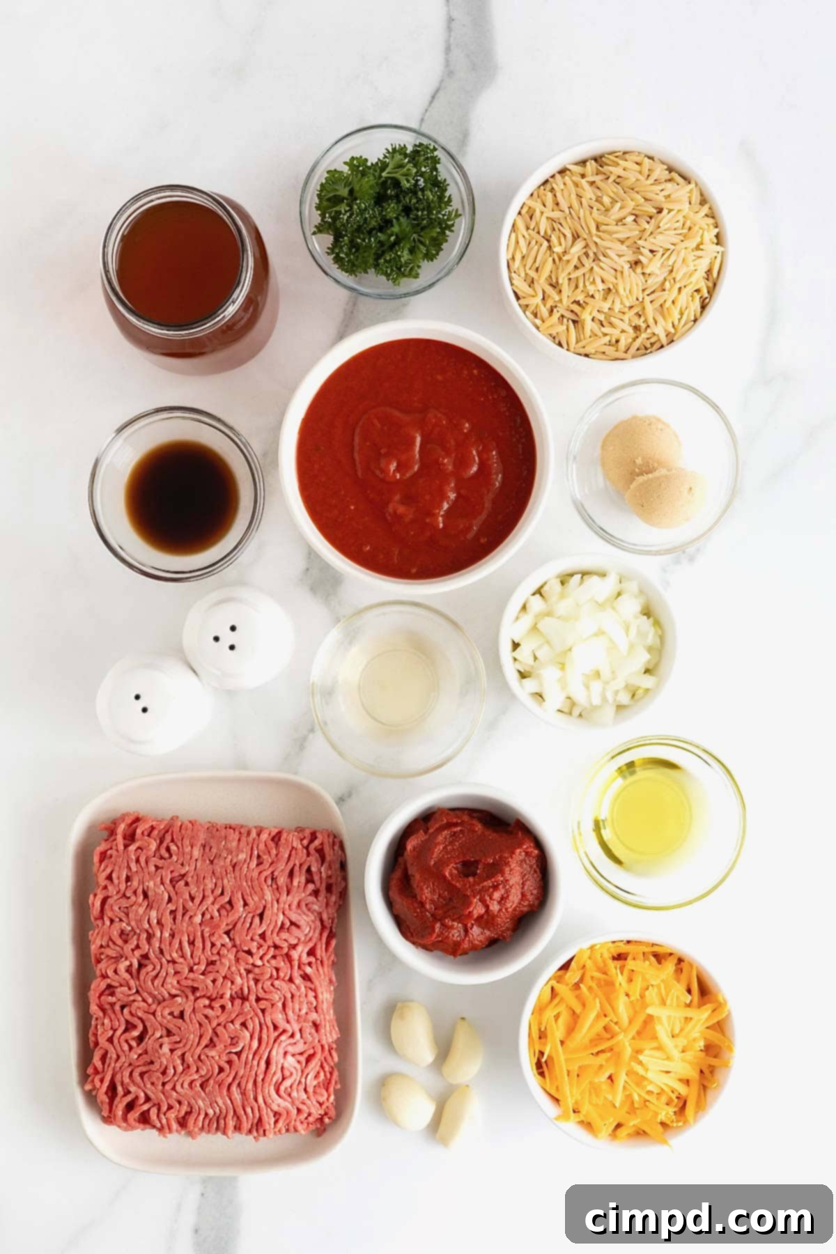 One-Pot Sloppy Joe Orzo 5 Ingredients to make Sloppy Joe Orzo in small glass dishes on a white marble counter.
