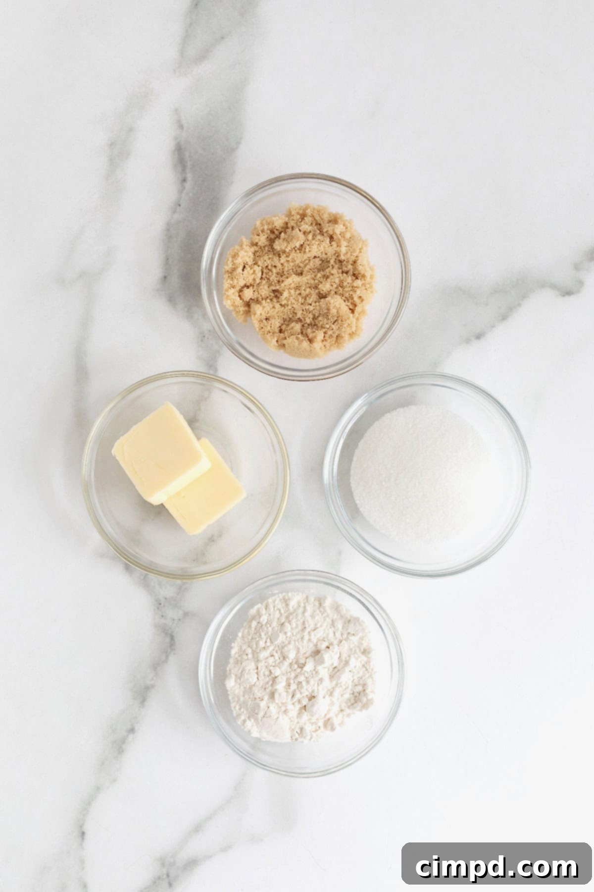 Homemade Streusel Simplified 5 Ingredients to make streusel in small glass dishes on a white marble counter, neatly arranged.