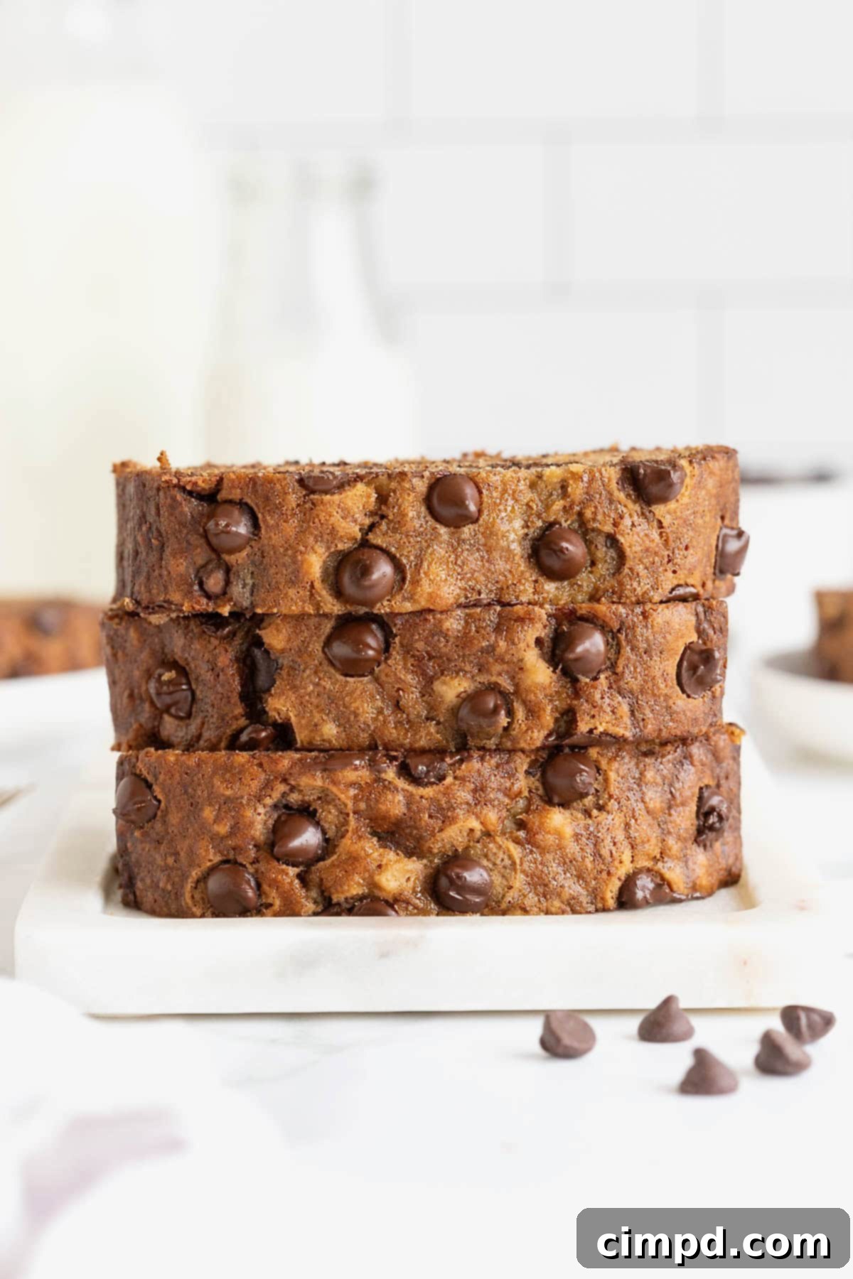 A stack of three slices of chocolate chip brown butter banana bread.