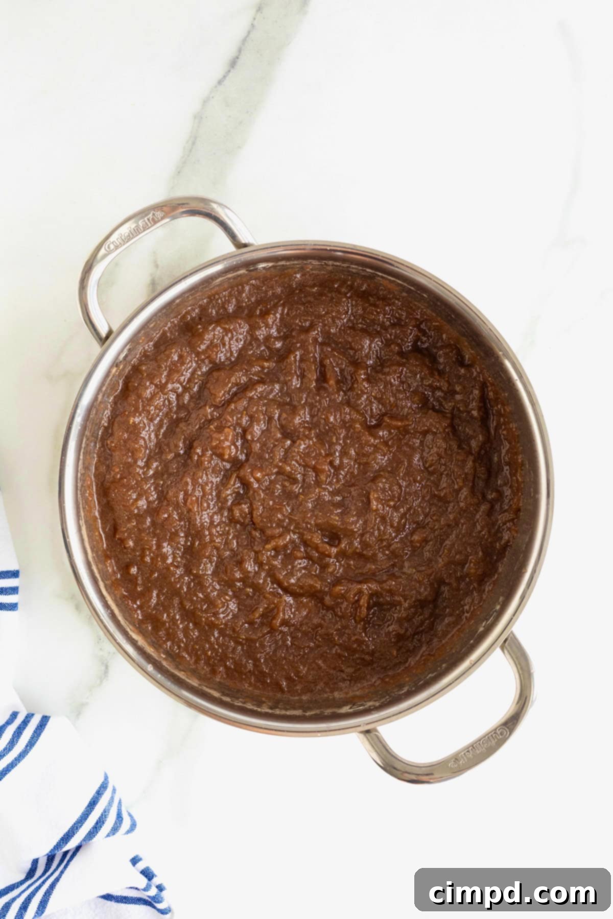 Effortless Homemade Grape Jam 7 A shallow stainless steel pot of homemade grape jam, now cooled down to room temperature, awaiting transfer to storage containers.