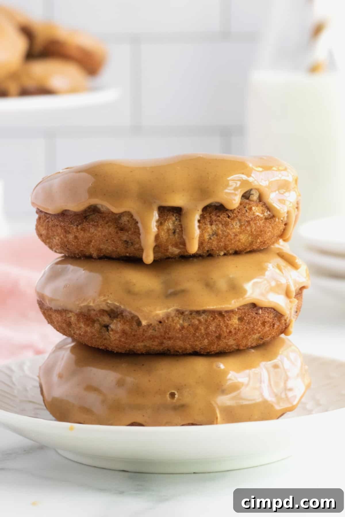 Delicious Whole Wheat Baked Banana Donuts with a creamy Peanut Butter Glaze, a healthier breakfast option from The BakerMama