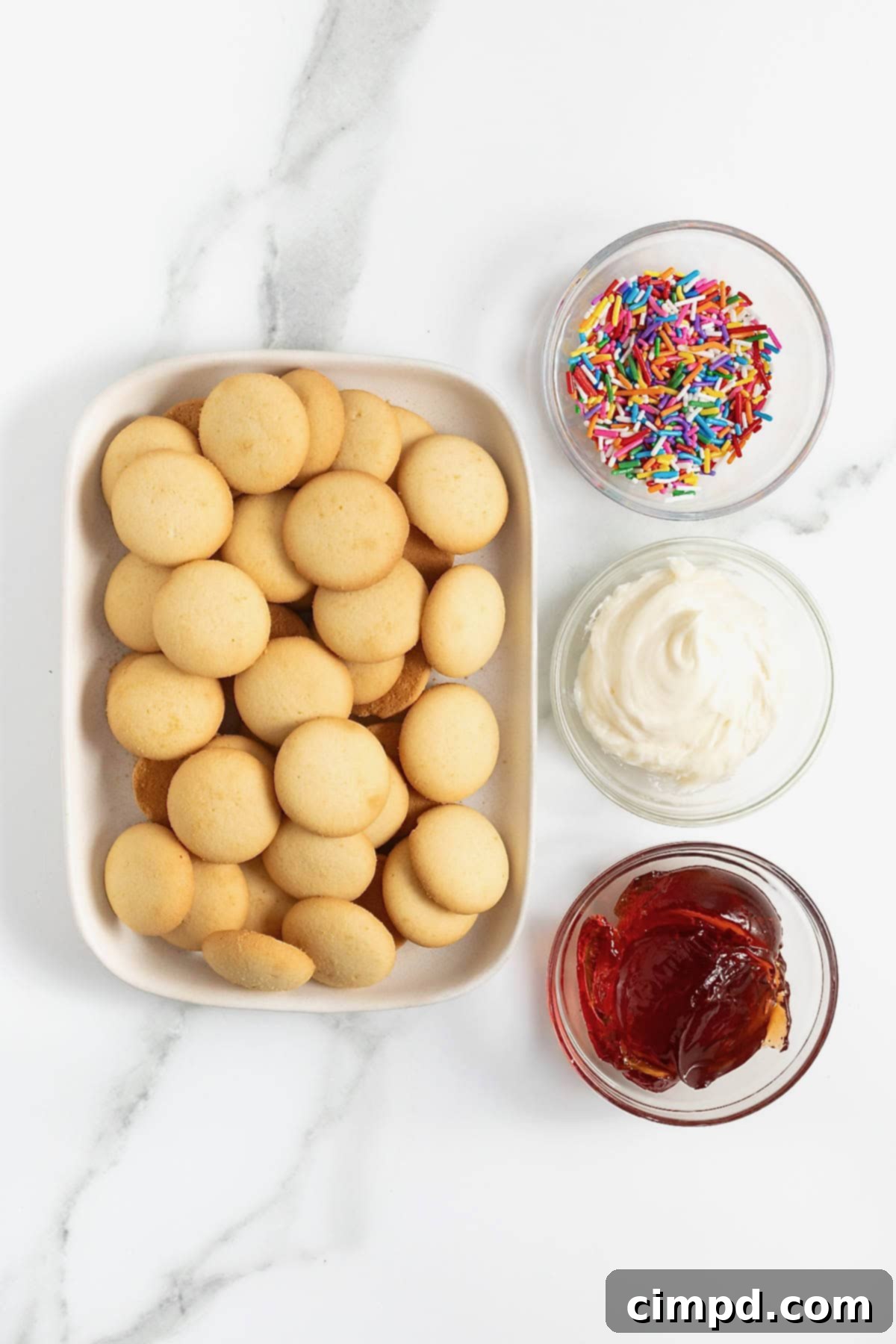 Ingredients to make Nilla wafer pop tarts in small dishes on a white marble counter.