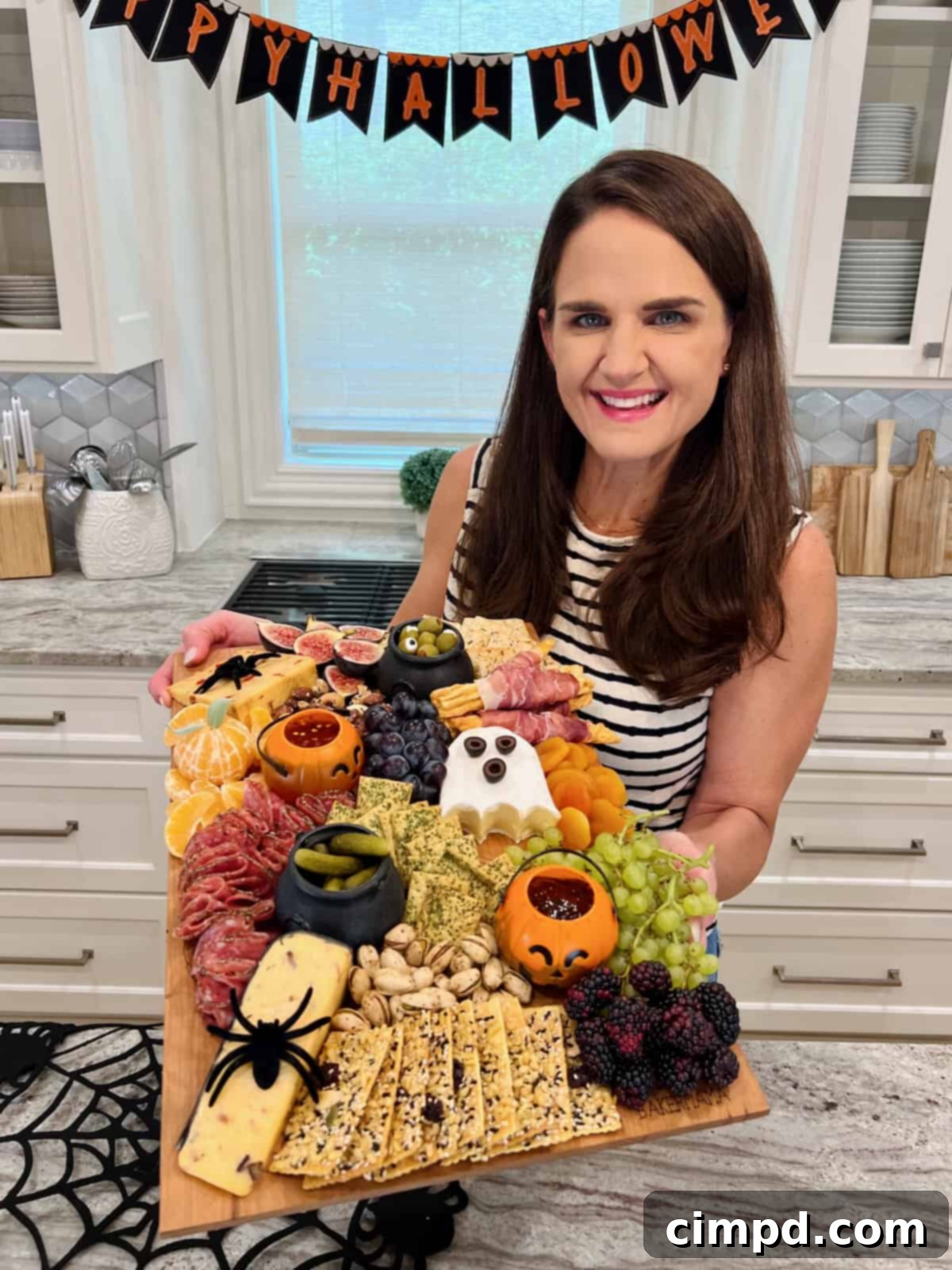 Maegan Brown holding her Halloween Signature board.