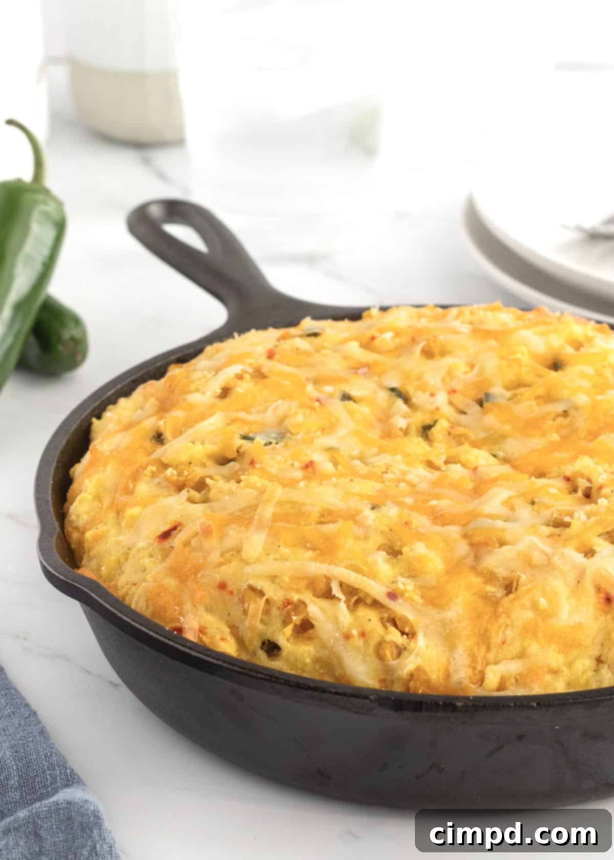 Crispy Cheesy Corn Cornbread in a cast iron skillet, golden brown and inviting.