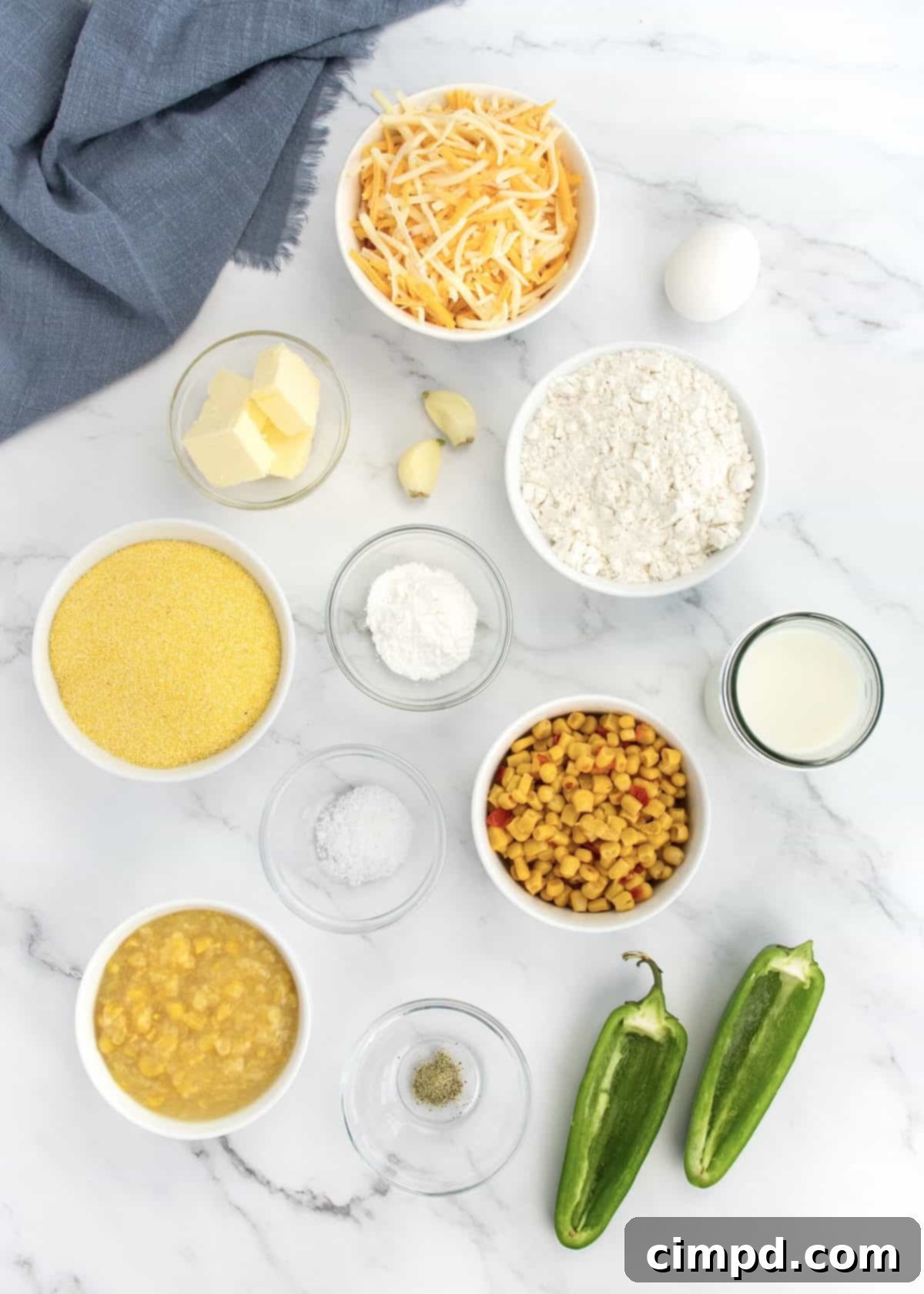 Ingredients laid out for Cheesy Corn Cornbread preparation.