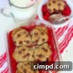 Cherry Chocolate Chip Cookie Cobbler with a scoop taken out