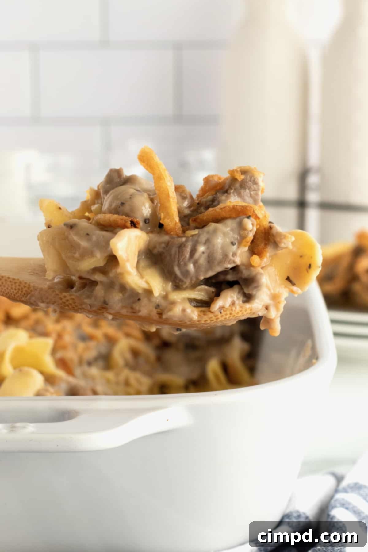 Beef Stroganoff Casserole ready to bake, topped with crispy fried onions