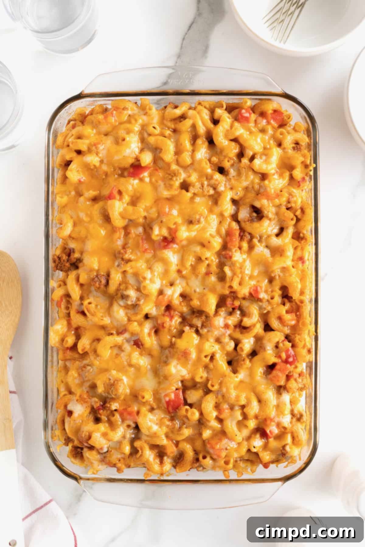 Fiesta Mac and Cheese 14 A 9x13 glass baking dish with Mexican macaroni casserole, freshly baked with a bubbly, melted cheese topping, fresh out of the oven.