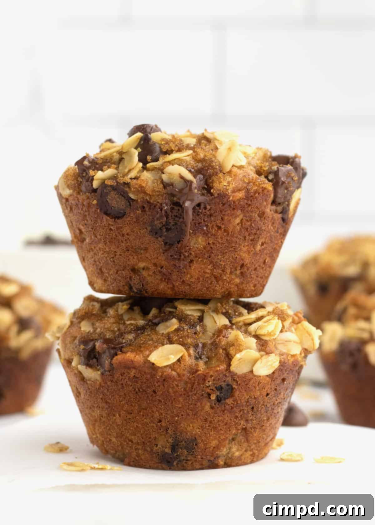 Greek Yogurt Chocolate Chip Oat Muffins 7 A basket full of golden-brown Oatmeal Chocolate Chip Greek Yogurt Muffins, showing their fluffy texture and delicious streusel topping.