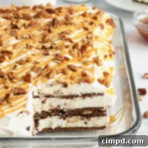 Ice cream sandwich cake topped with whipped cream, chopped pecans and a caramel drizzle in a pyrex dish.