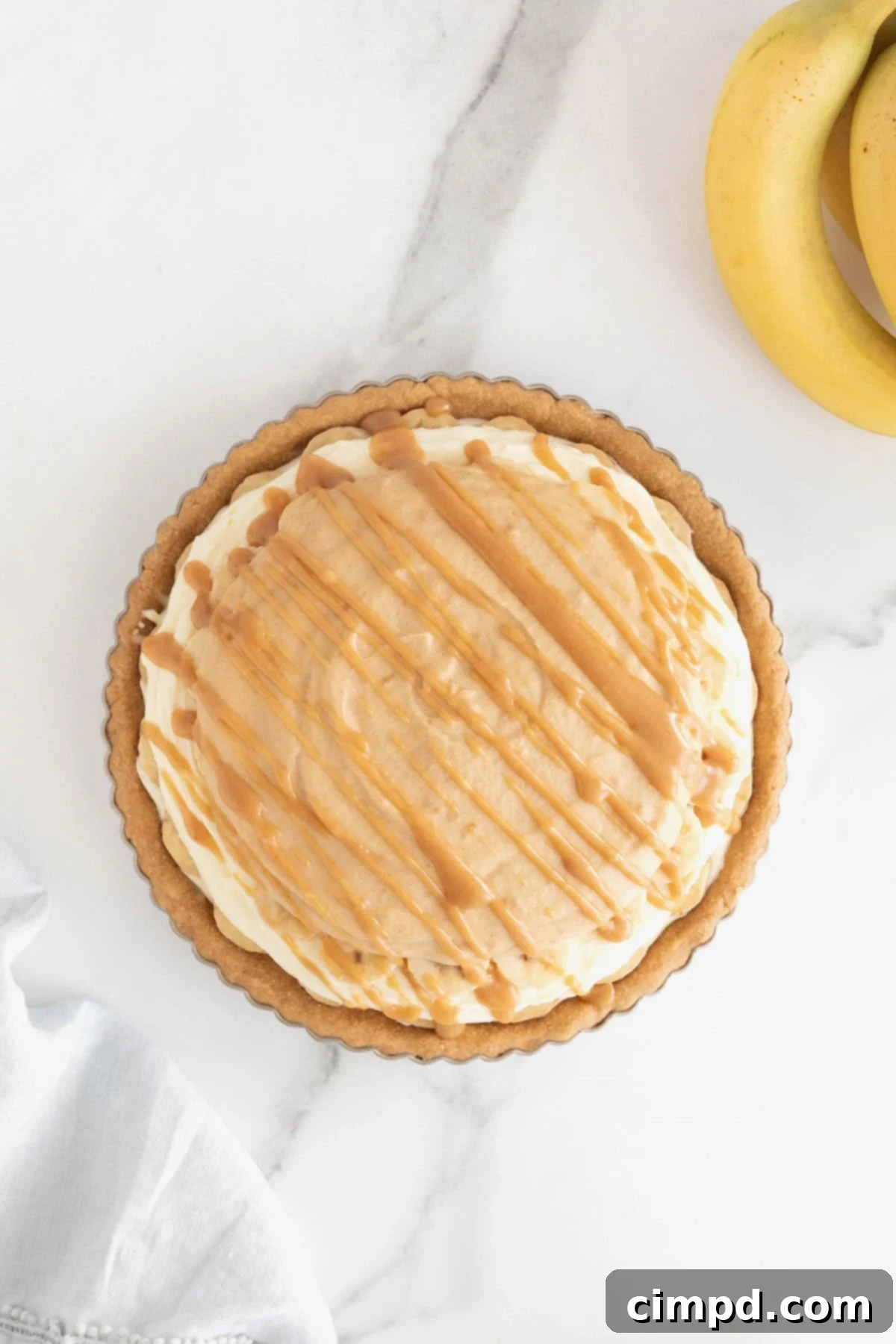 Peanut butter sauce drizzled over a banana cream pie.