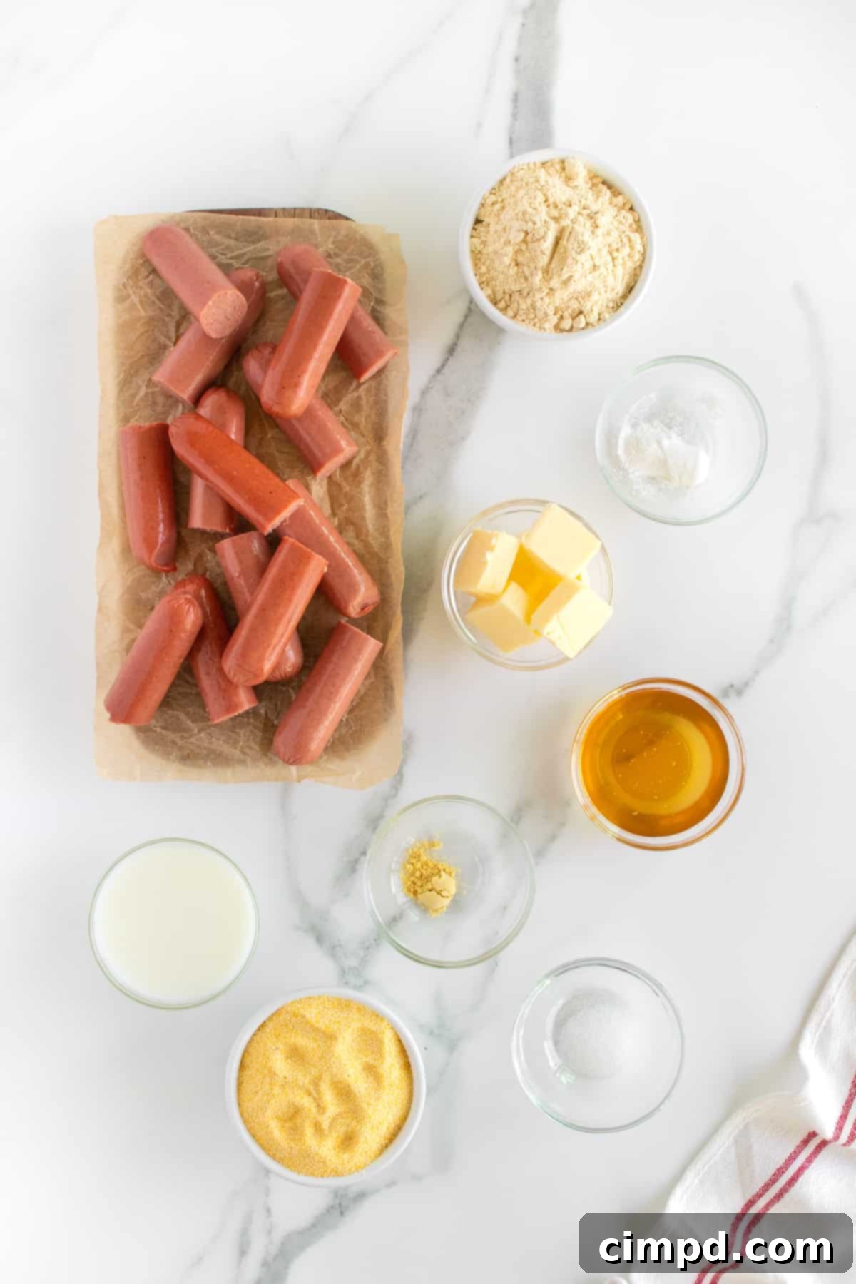Two children, Baker and Audrey, happily eating baked corn dogs, illustrating their appeal to kids.