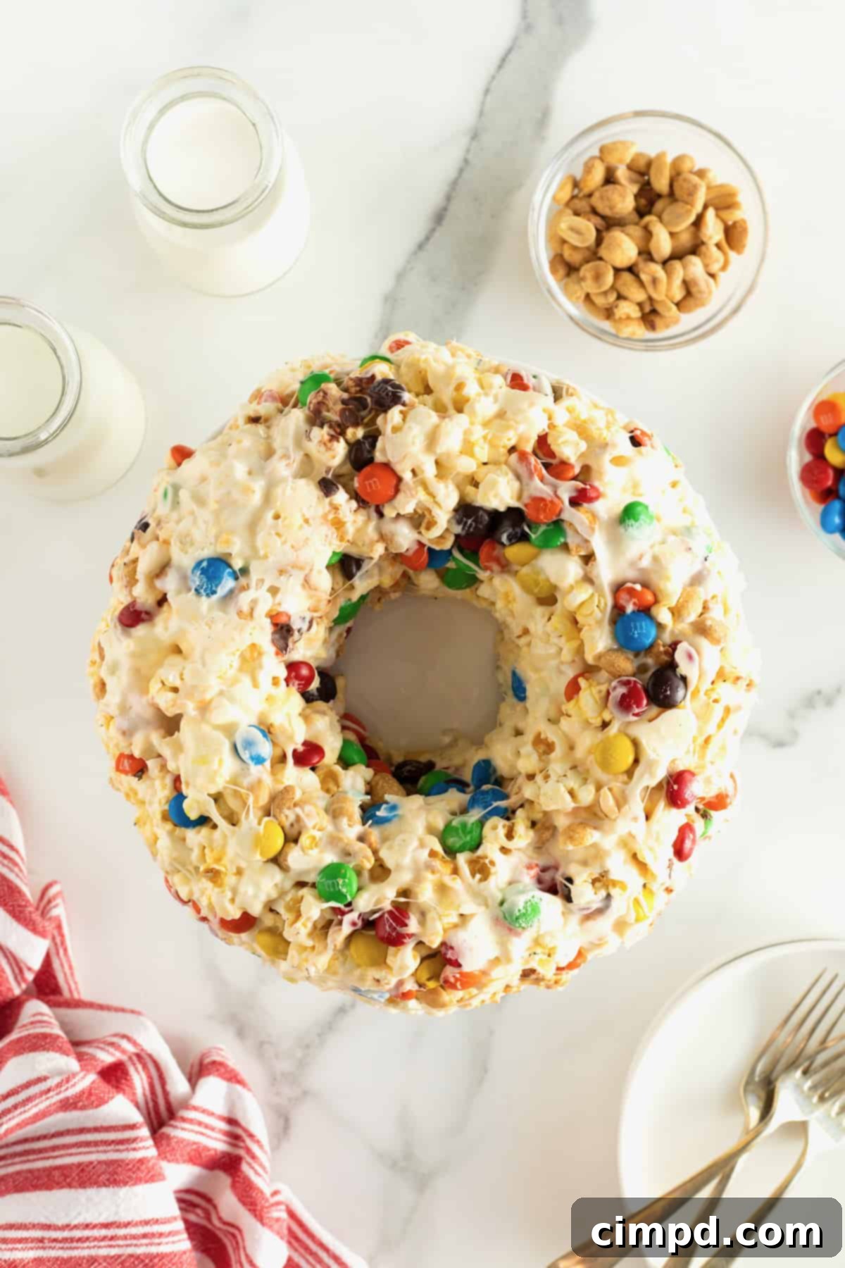 A completed popcorn cake, elegantly molded into a bundt shape and displayed on a pristine white cake platter.