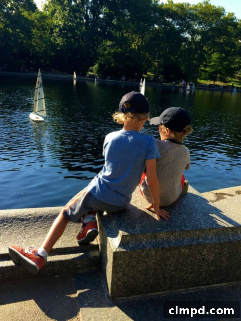 Boy concentrated on sailing a remote-control boat