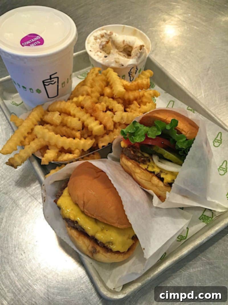 Delicious Shake Shack meal with burgers, fries, and drinks
