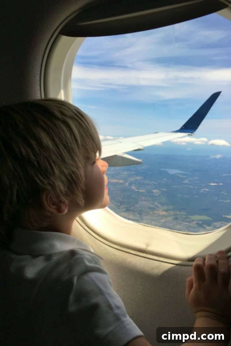 Young boy Baker excitedly enjoying airplane snacks