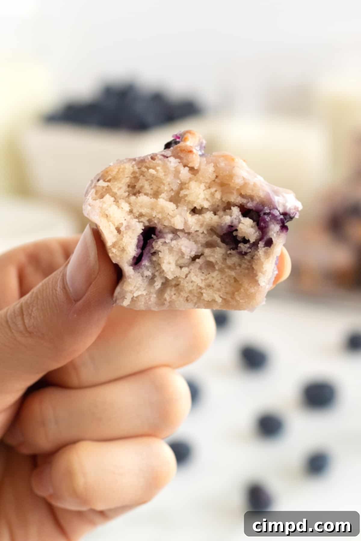Oven-Baked Blueberry Fritter Poppers 3 Close-up of a stack of glazed Baked Blueberry Fritter Bites, showcasing their delicious texture.